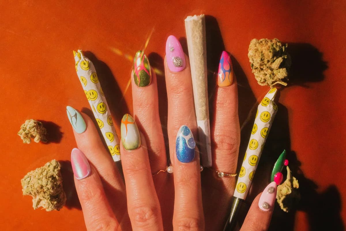 An overhead shot of a hand with a different hand painted design on every nail.